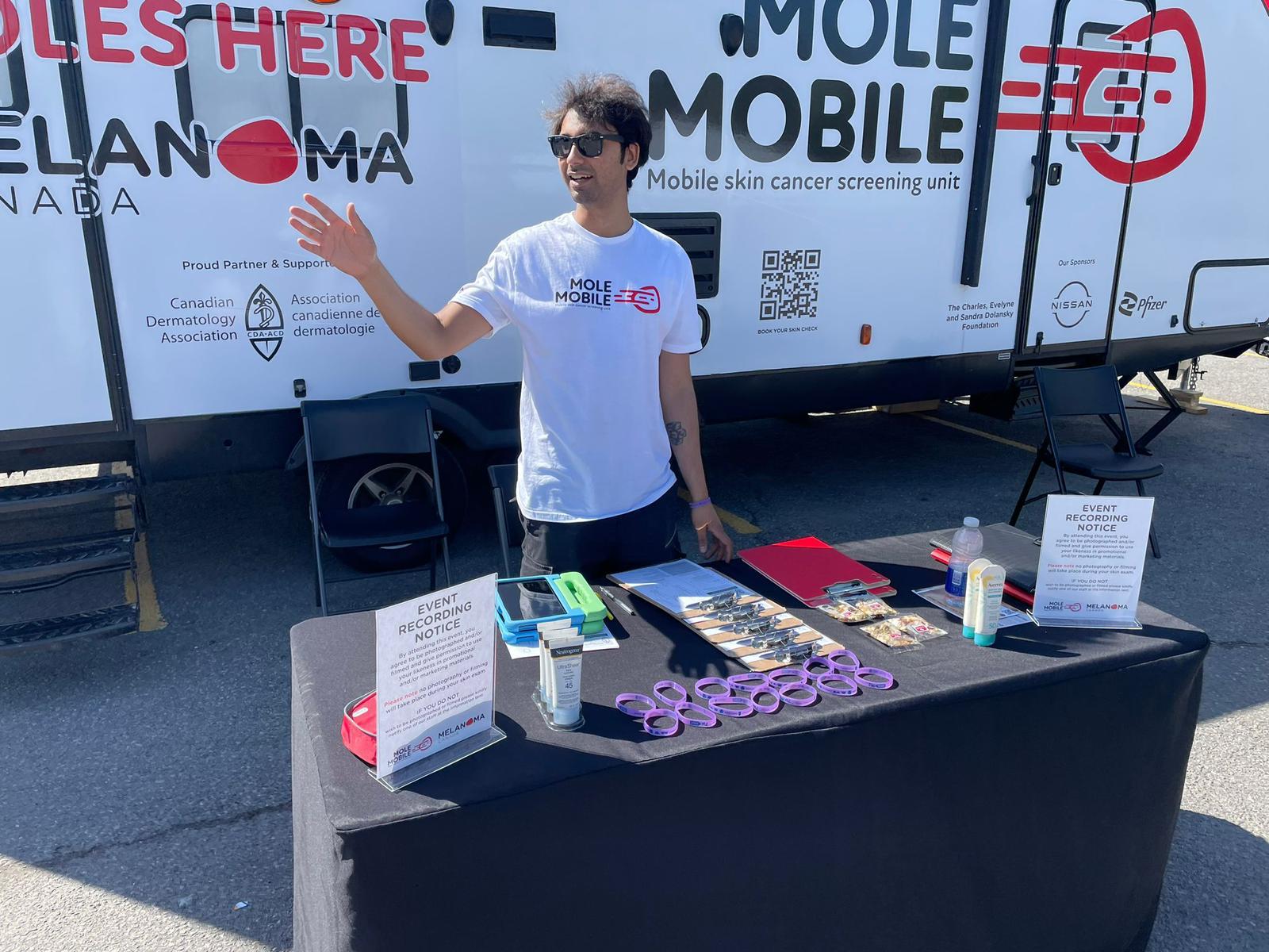 A Mole Mobile team member welcoming visitors at the campaign engagement table.