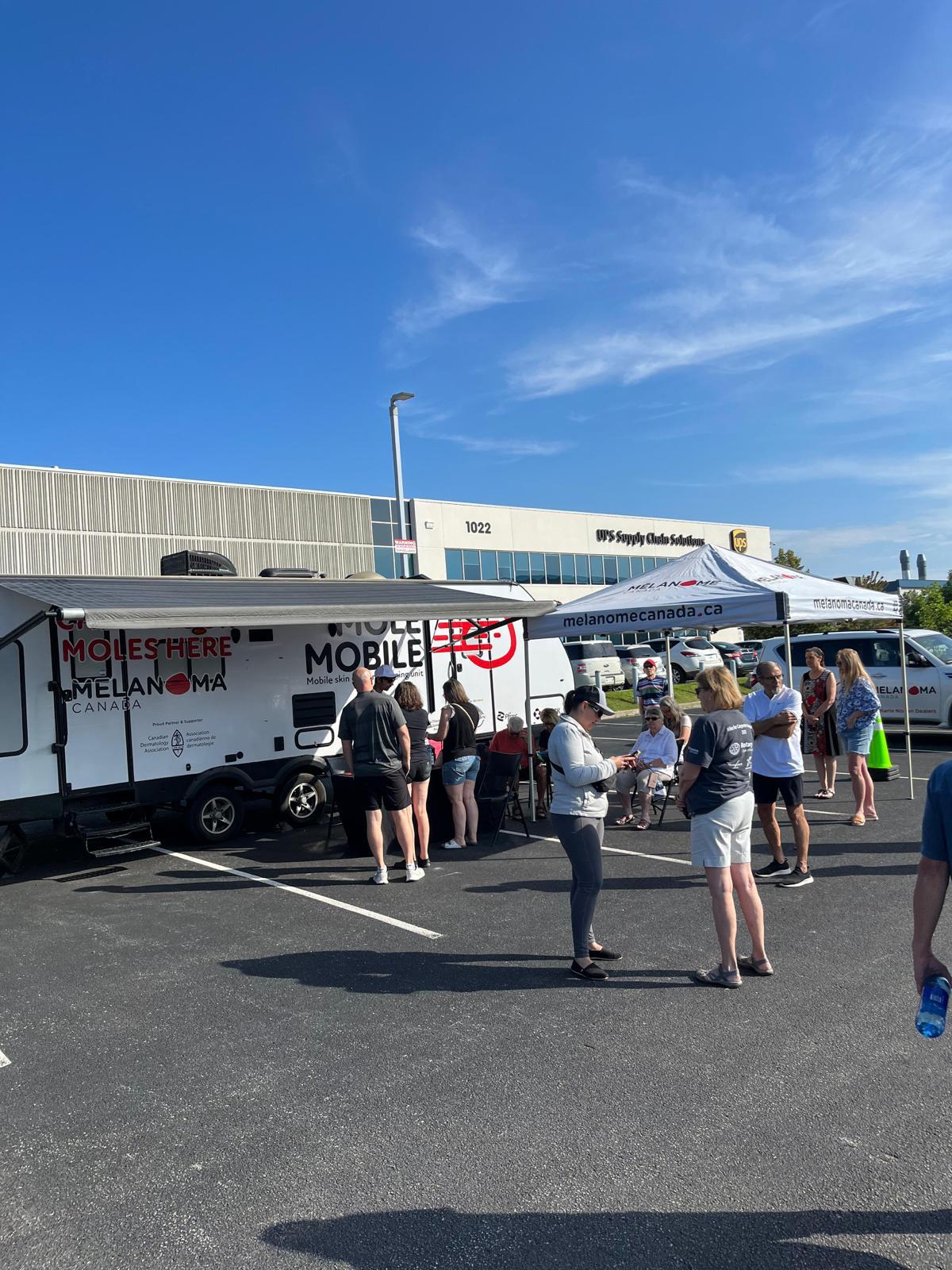 Community members visiting the Mole Mobile screening footprint during a campaign stop.