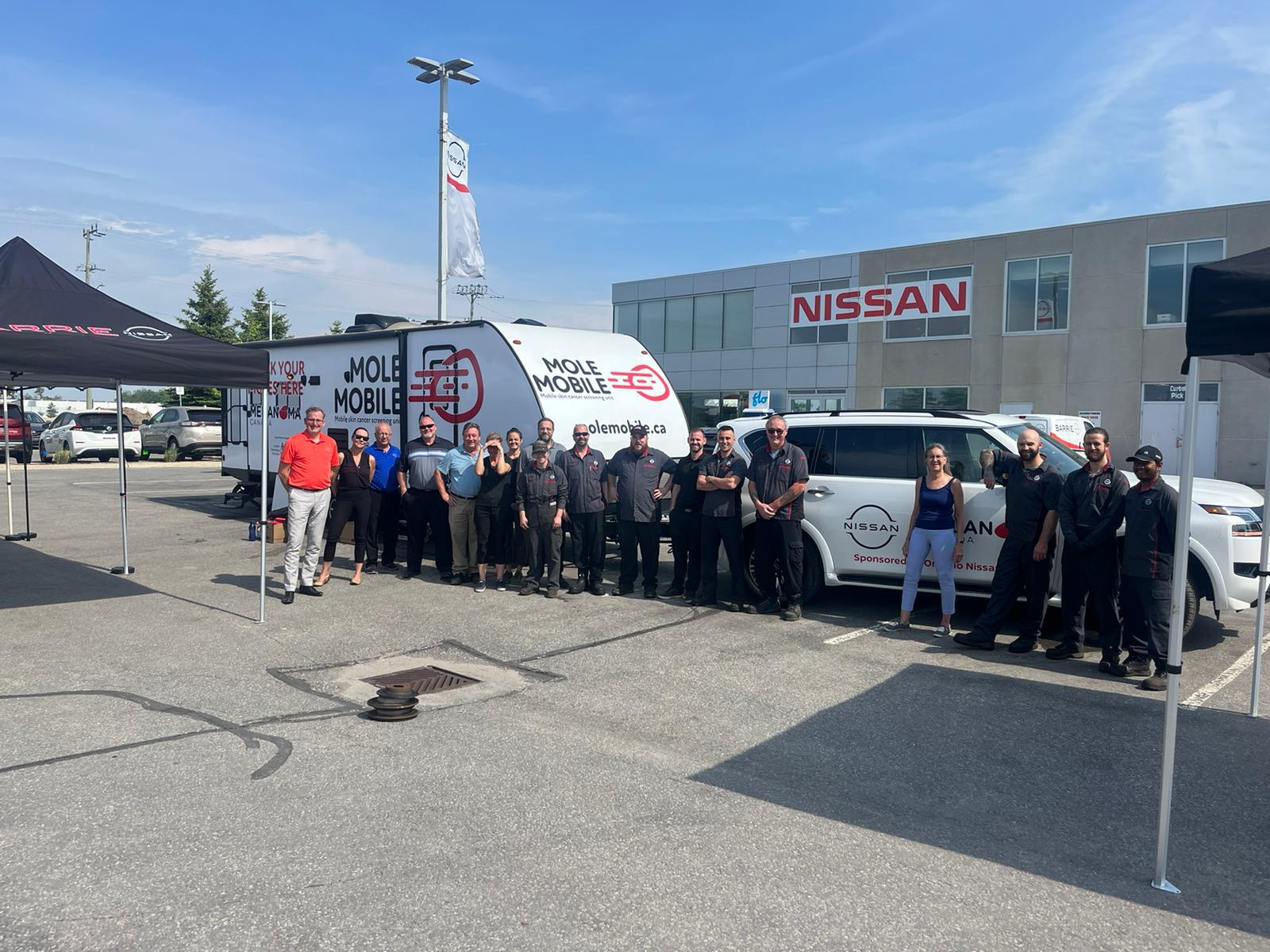 Campaign partners and team members gathered beside the Mole Mobile and sponsored vehicle.